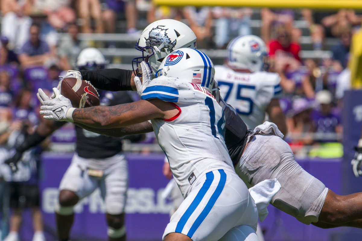 TCU Horned Frogs linebacker Namdi Obiazor (4) breaks up a pass intended for SMU Mustangs tight end Nolan Matthews-Harris (14) during the second half at Amon G. Carter Stadium. 